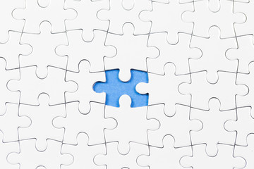 Blue background made from white puzzle pieces and place for your content 