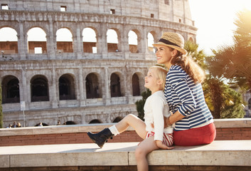 Wall Mural - happy mother and child travellers looking into distance