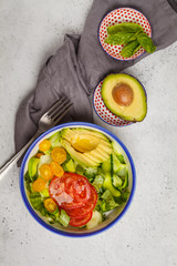 Canvas Print - Green zucchini noodles salad with tomatoes, avocado and basil. Healthy vegan zucchini pasta.