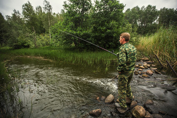 Wall Mural - Fisherman catching fish on the river.