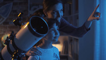 Cute Sisters Watching The Stars With A Telescope