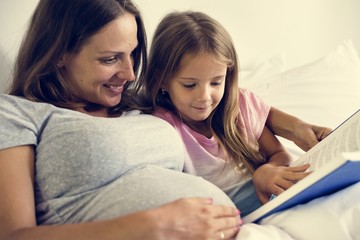 Wall Mural - Pregnant woman with her daughter 