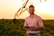 © Zoran Zeremski - Young farmer in filed holding tablet in his hands and examining soybean corp.