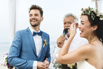 Wall Mural - Young couple in a wedding ceremony at the beach