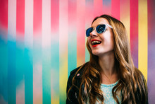 Happy Young Blonde Woman In A Colorful Background
