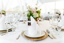 Table Setting On A White Tablecloth In The Restaurant Close-up