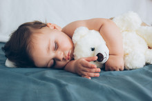 Beautiful Baby Sleeping With His Teddy Bear Aside, Family Concept
