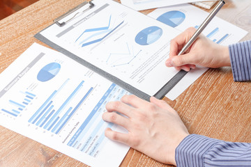 business man analyzing graph and chart document report