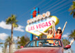 summer holidays, road trip and travel concept - happy friends driving in convertible car and waving hands over welcome to fabulous las vegas sign background