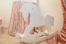 White Toy Rocking Horse On The Pink Background