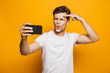© Drobot Dean - Portrait of an excited young man taking a selfie