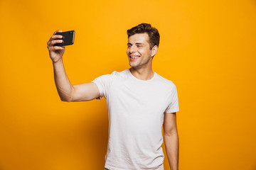 Sticker - Portrait of a cheerful young man taking a selfie