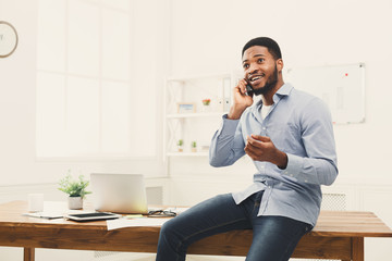 Poster - Young black businessman having phone talk