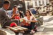 © BalanceFormCreative - Group of friends hangout at the street.They drinking cold juice.Fast food.
