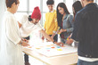 © ChayTee - Multiethnic creative team working together, meeting and brainstorming on table in workplace. Startup diversity teamwork brainstorming meeting with post it notes on desk concept