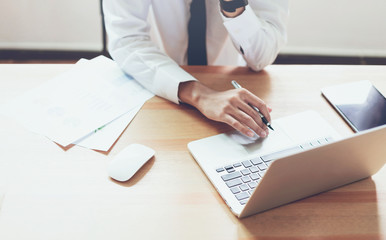 Businessman working on laptop at office room of design ideas. Vintage tone.