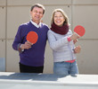 © caftor - Happy mature man and a woman playing table tennis