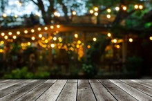 Empty Modern Wooden Terrace With Abstract Night Light Bokeh Of Night Festival In Garden, Copy Space For Display Of Product Or Object Presentation, Vintage Color Tone