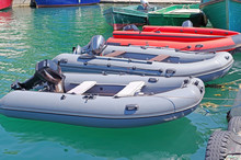 Inflatable Boat Moored At The Coast Clear