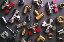 Group Of Plumbing Fittings And Equipment On Wooden Background