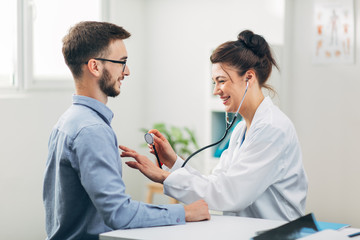 Wall Mural - Doctor Examining Patient in Office