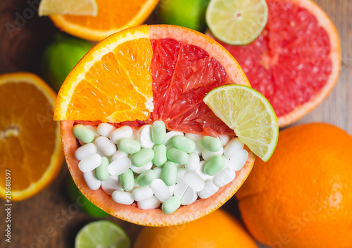 Fotografie, Obraz Vitamin C in citruses and supplement. Concept