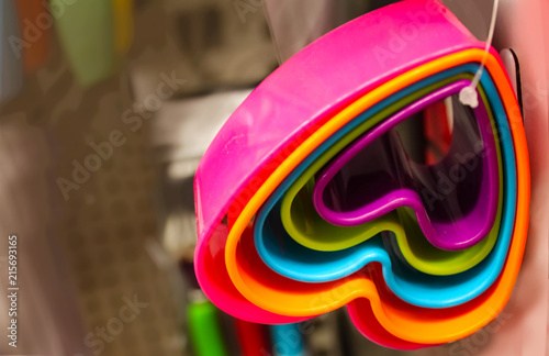 Fotografie, Obraz Set of heart-shaped brightly colored cookie cutters hanging from a plastic tie a