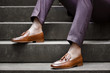 Hipster man wear fashion shoes tassel loafer.On old  floor. Stylish men shoes concept.