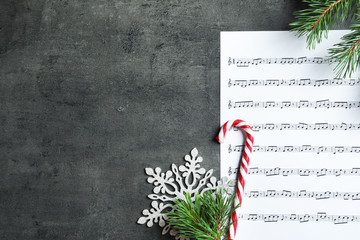 Sticker - Flat lay composition with candy cane, fir branches and music sheet on table. Christmas songs concept