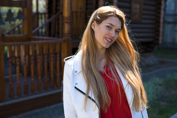 Wall Mural - Beautiful young blonde girl in red blouse. Street fashion look.