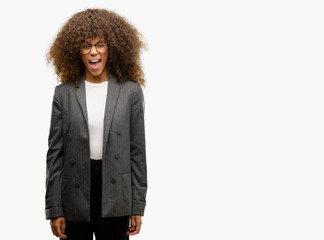 Canvas Print - African american business woman wearing glasses winking looking at the camera with sexy expression, cheerful and happy face.