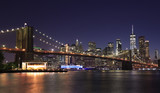 Fototapeta  - Panorama of Brooklyn Bridge and New York City (Lower Manhattan) with lights and reflections at dusk, USA