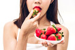 Woman eating fresh strawberry on white background.dieting concept.healthy lifestyle
