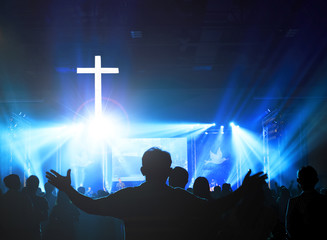 Wall Mural - church worship concept:christians raising their hands in praise and worship at a night music concert