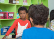 © weedezign - African american boy angry and looking at friend in school library in kindergarten.kids education concept.