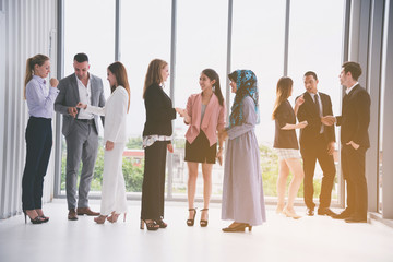 Business people team are standing with talking about working on their business project and relaxing while waiting for the meeting