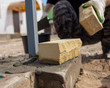 The worker lays bricks on the construction site