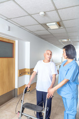 Poster - Asian nurse helping elderly man with walker in hospital aisle