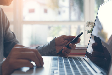 Man working using smart phone and laptop computer