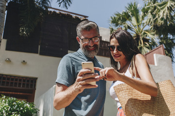couple using their phone while on vacation