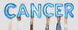 © Rawpixel.com - Hands showing cancer balloons word