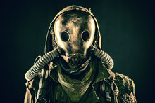 Close Up Portrait Of Nuclear Post-apocalypse Survivor, Living Underground Mutant Or Creature, Skilled Stalker Wearing Rags And Armored Full-face Gas Mask Or Air Breathing Apparatus, Toned Shoot