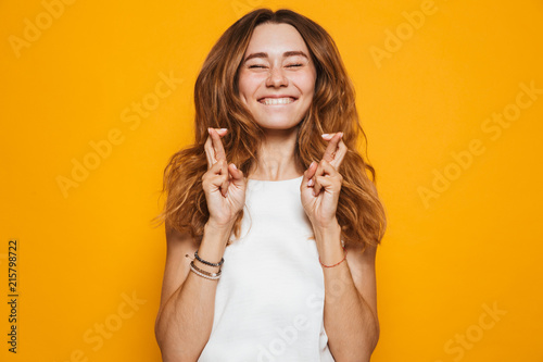 Portrait of an excited young girl holding fingers Tableau sur Toile