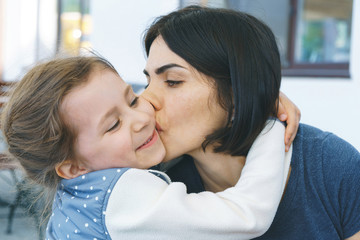 Wall Mural - Mother Kissing Daughter in Cheek