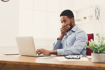 Poster - Young black businessman working with laptop