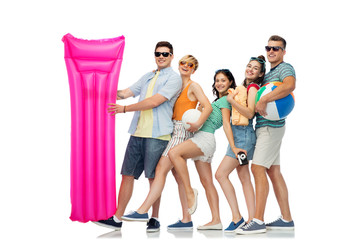 Wall Mural - summer holidays and people concept - group of happy smiling friends in sunglasses with beach ball, volleyball, towel, camera and air mattress over white background