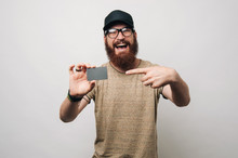 Happy Bearded Man Pointing At Credit Card