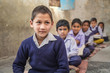 Portrait of Indian village boy in classroom at school.