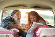 © jackfrog - Old hipster couple sitting in a car and looking at a road map