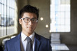 © Monkey Business - Young Asian businessman looking to camera, head and shoulders